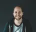 man in black jacket smiling